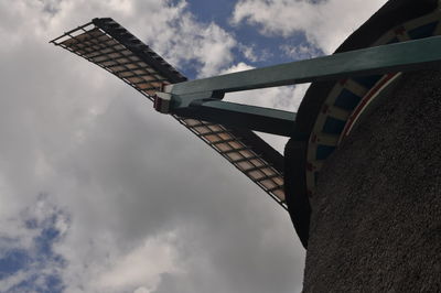 Low angle view of traditional windmill against sky