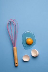 High angle view of eggs on table against blue background