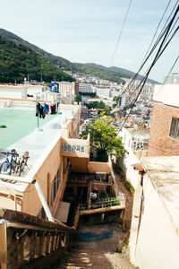 High angle view of steps by sea in city against sky