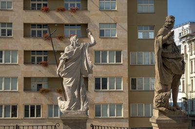 Statue against building in city