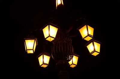 Close-up of lit candle in darkroom