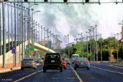 View of city street against cloudy sky