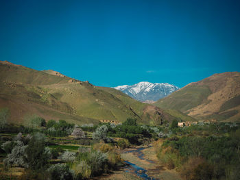 Scenic view of mountains against clear blue sky