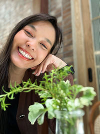 Portrait of young woman sitting on table