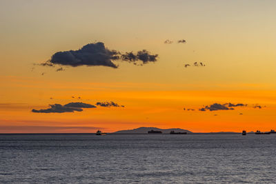 Scenic view of sea against orange sky