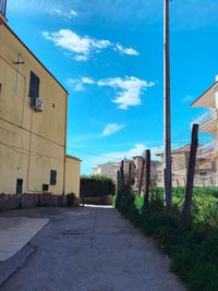 Street amidst buildings against sky