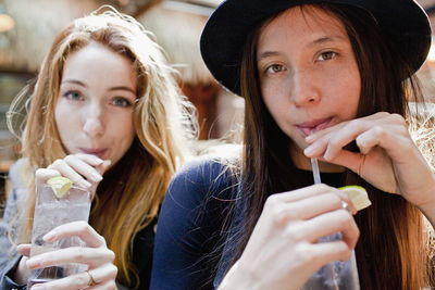 Happy young friends enjoying drinks at a bar