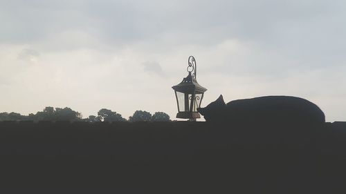 Low angle view of silhouette built structure against sky