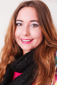 Close-up portrait of redhead young woman against white background