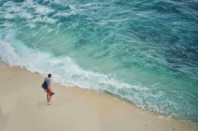 High angle view of woman standing on beach