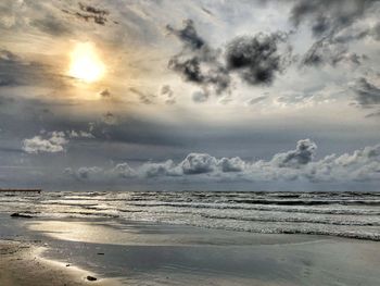 Scenic view of beach against sky during sunset
