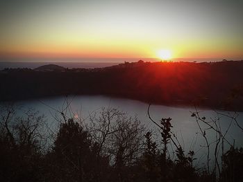 Scenic view of lake against sky during sunset