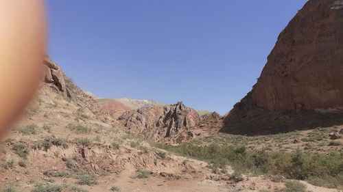 Scenic view of rocky mountains against clear blue sky