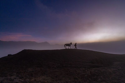 Scenic view of silhouette mountains against sky during sunset