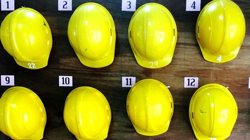 Close-up of hardhats hanging on wall