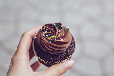 Midsection of person holding cake