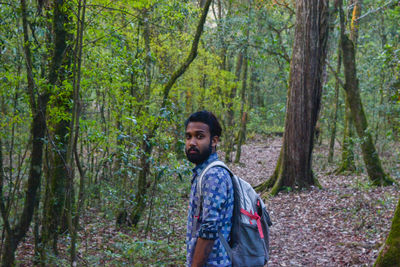 Young man standing in forest