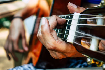 Close-up of hand playing guitar