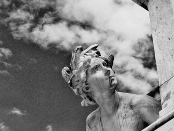 Low angle view of statue against cloudy sky