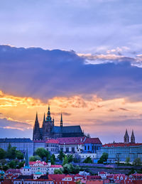 Buildings in city against sky during sunset