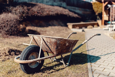 Close-up of rusty wheel on field