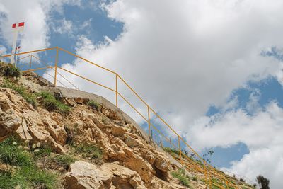 Low angle view of bridge over mountain against sky