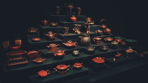 Various antique teapots against black background