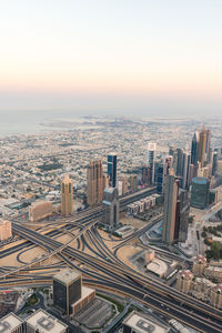 High angle view of city buildings against sky during sunset