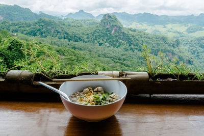 Soup on table against countryside landscape