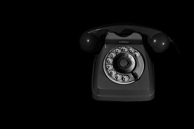 Close-up of telephone booth against black background