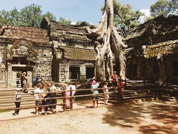 People at temple against sky