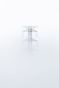 Electricity pylon against clear sky