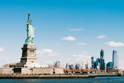 Statue of liberty with city in background