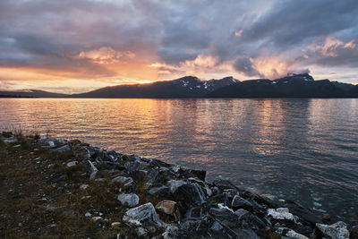 Scenic view of a beautiful and colorful sunset over mountains and sea in norway