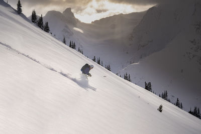 People skiing on snowcapped mountain