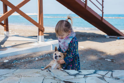 Girl with dog on shore