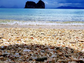 View of pebbles on beach against sky