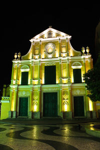 Low angle view of illuminated building at night