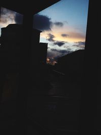 Silhouette of built structure against sky at sunset