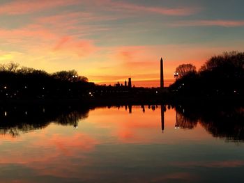 Scenic view of lake against orange sky