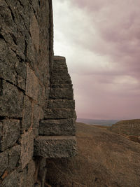 Low angle view of rocks on land against sky