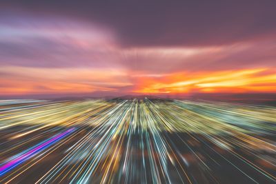 Light trails against sky at sunset