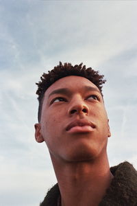 Portrait of young man against sky