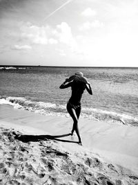 Full length of man on beach against sky