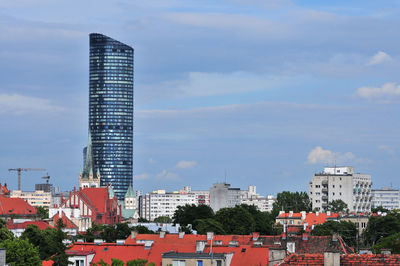 Modern buildings in city against sky