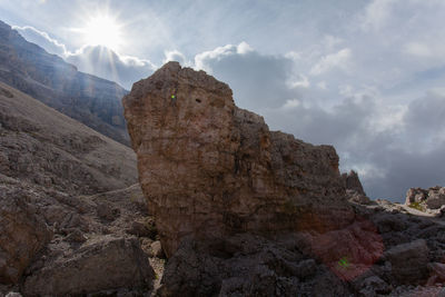 Low angle view of rock formation against sky