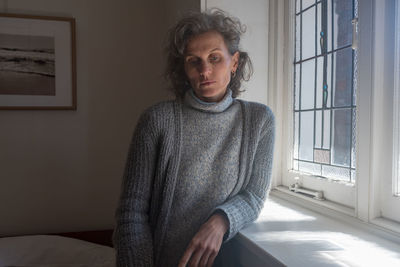 Portrait of young woman sitting at home