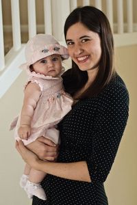 Portrait of happy mother with baby at home