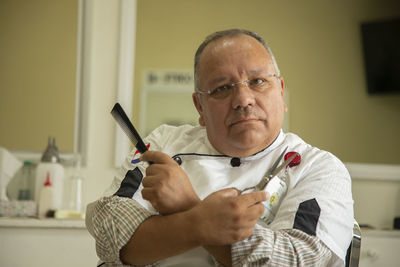 Portrait of man holding camera