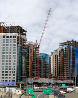 Low angle view of buildings being built against sky in city. boston 